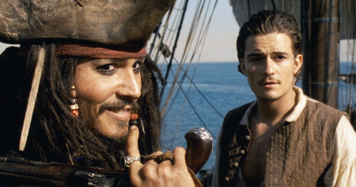 Johnny Depp as Jack Sparrow and Orlando Bloom as Will Turner in Pirates of the Caribbean: The Curse of the Black Pearl