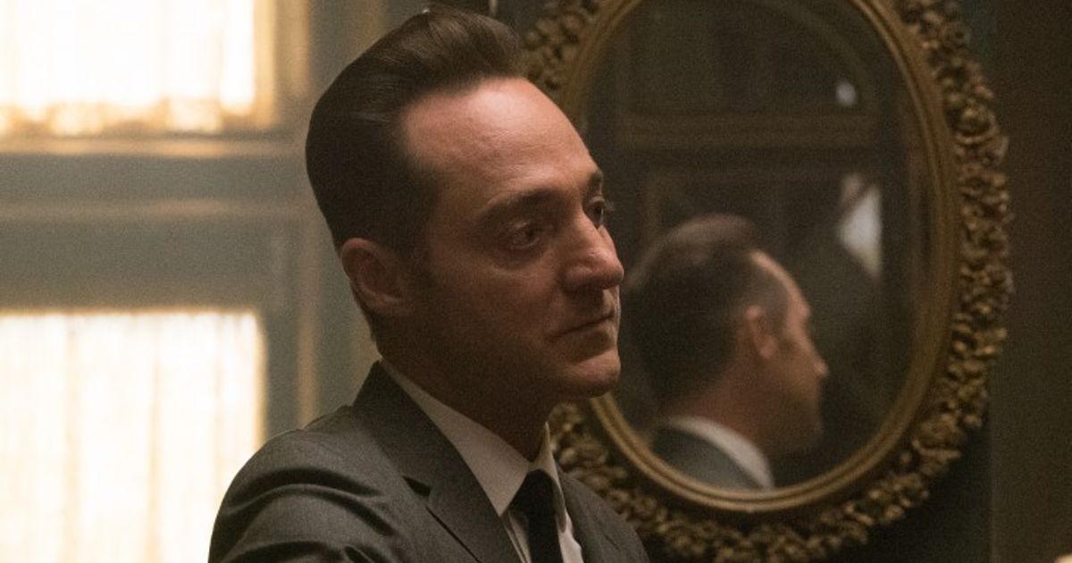 Robert stands by a mirror in The Man in the High Castle