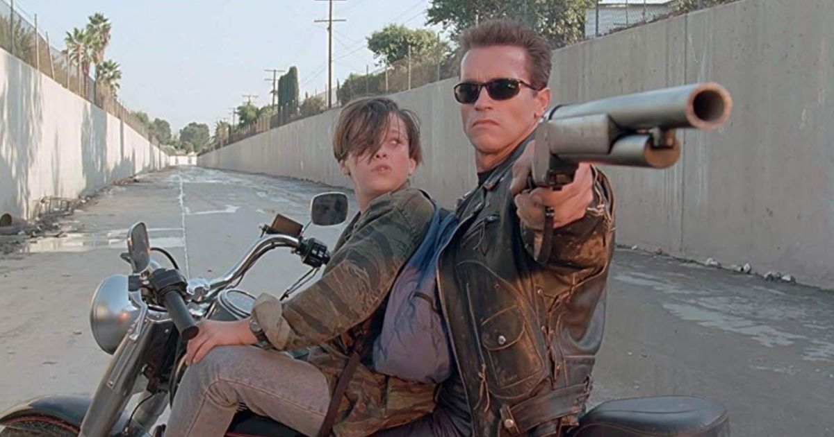 The Terminator and Sara Connor escaping on a motorcycle while shooting at something behind them